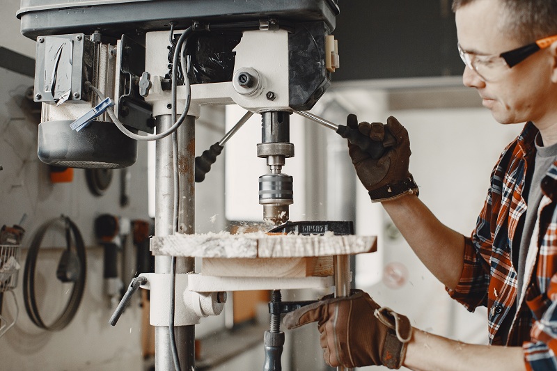 A man working on Vertical Turning Lathe Machines